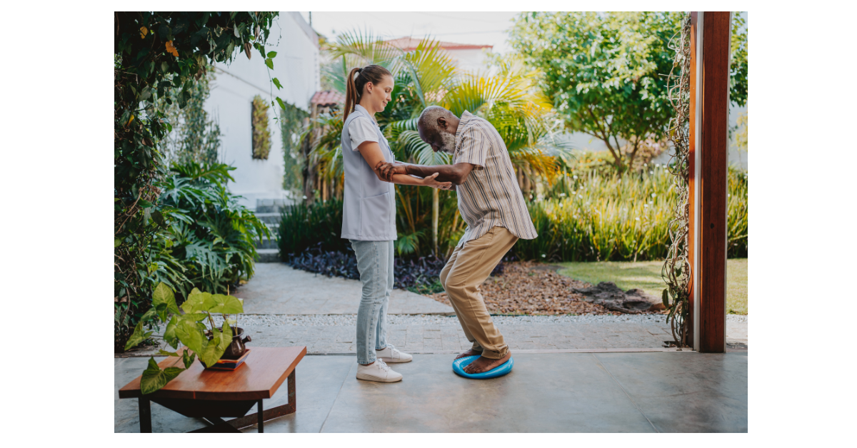 Neurological physiotherapist guiding a patient through a strengthening exercise.